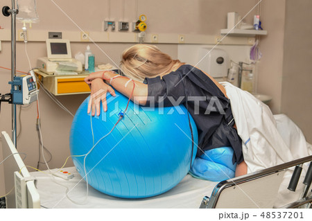Woman during contractions on a fitness ball Parturition hospital Woman during contractions on a fitness ball Parturition hospital 48537201