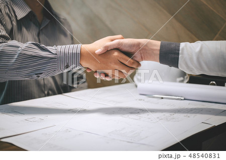 Construction engineering or architect discuss a blueprint while Construction engineering or architect discuss a blueprint while 48540831