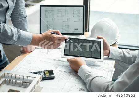 Construction engineering or architect discussing a blueprint and 48540853
