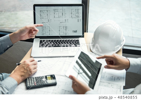 Construction engineering or architect discussing a blueprint and 48540855
