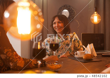 Pretty woman in a vintage pub smiling at her sister Pretty woman in a vintage pub smiling at her sister 48542102