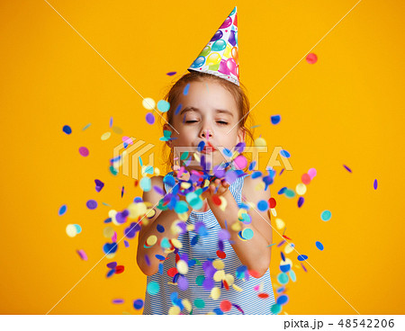 happy birthday child girl with confetti on yellow  48542206