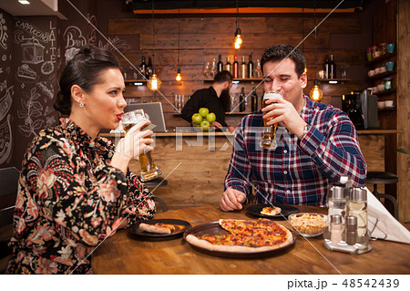 Lovely couple in new pub enjoying their beer. Lovely couple in new pub enjoying their beer. 48542439