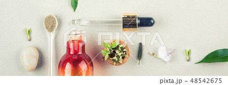 Natural cosmetics, serum skin and body care. Orange bottle with peep and plants. Flat lay 48542675