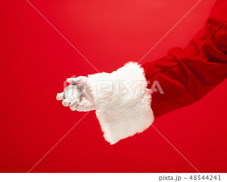 Santa holding a stopwatch in hand Santa holding a stopwatch in hand 48544241