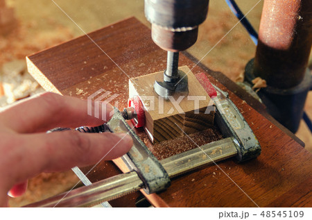 Der Meister macht ein Loch in den Holzrohling. Der Meister macht ein Loch in den Holzrohling. 48545109