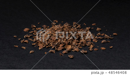 Grated chocolate. Heap of ground chocolate isolated on black background, closeup 48546408