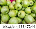 green apples in a wooden box 48547244