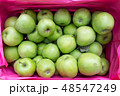 green apples in a wooden box 48547249