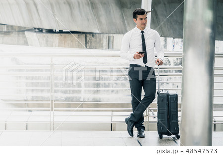 Business man standing with Luggage Trip concept 48547573
