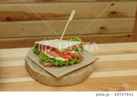 juicy sandwich with bacon, fresh vegetables, green 48547642
