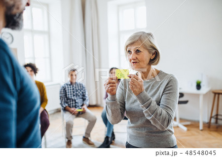 Men and women during group therapy, expressing negative emotions. 48548045