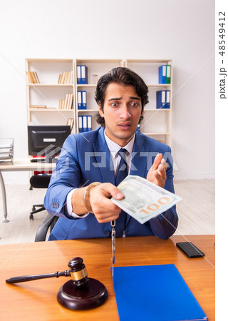 Young handsome judge sitting in courtroom   48549412