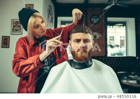 Client during beard shaving in barber shop 48550116