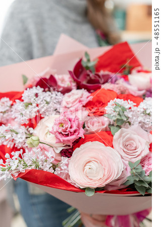 beautiful fresh cut bouquet of mixed flowers in woman hand. the work of the florist at a flower shop 48551165