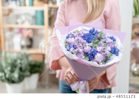 Bouquets of blue hyacinths and matthiola of lilac color in woman hand. Spring flowers from Dutch Bouquets of blue hyacinths and matthiola of lilac color in woman hand. Spring flowers from Dutch 48551173