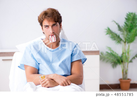 Young male patient lying on couch in hospital Young male patient lying on couch in hospital 48551785