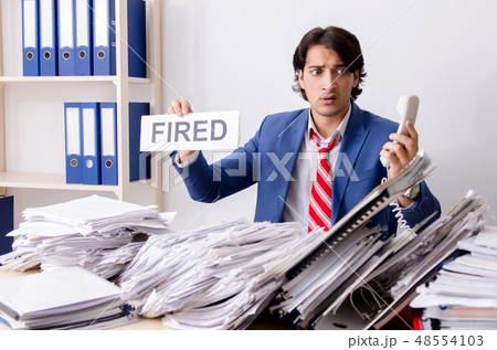 Young businessman employee unhappy with excessive work  48554103