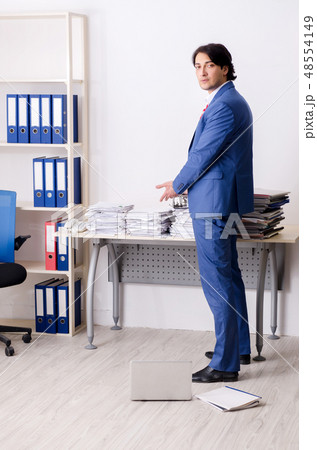 Young businessman employee unhappy with excessive work Young businessman employee unhappy with excessive work 48554149