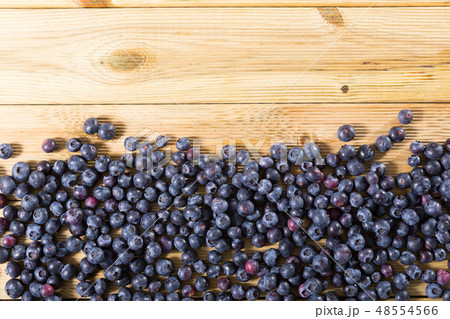 Fresh delicious blueberries on wooden table 48554566