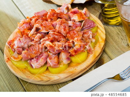 Close up of raw pig's ear with species at plate on table 48554685