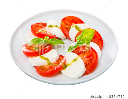 Caprese salad with fresh tomatoes, mozzarella cheese and basilic herb Caprese salad with fresh tomatoes, mozzarella cheese and basilic herb 48554732