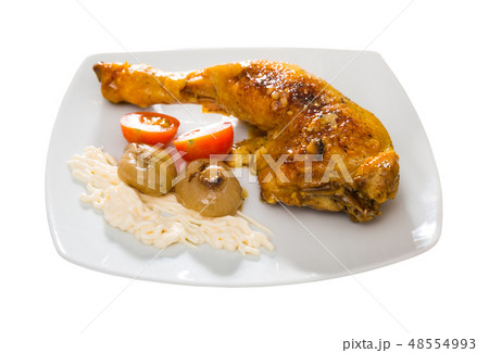 Grilled chicken leg quarter with baked onions and sauce 48554993