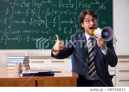 Young male math teacher in classroom  48556831
