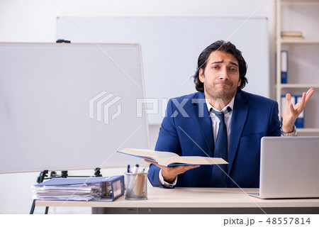 Young handsome businessman working in the office 48557814