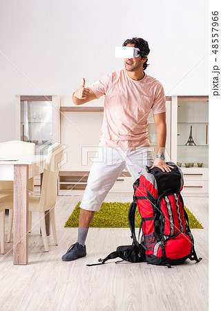Young male tourist with virtual glasses preparing for trip  48557966