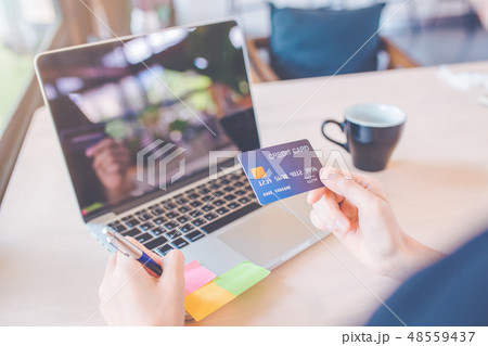 Business women use credit cards and laptop 48559437
