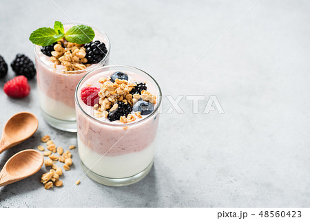 Berry yogurt with fresh berries and granola in jar 48560423