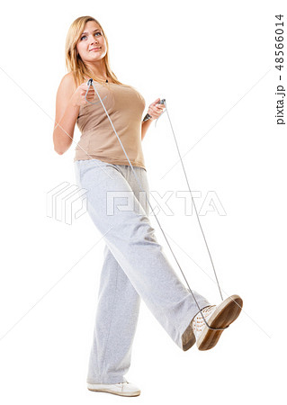 sporty girl plus size doing exercise with jump rope. sporty girl plus size doing exercise with jump rope. 48566014