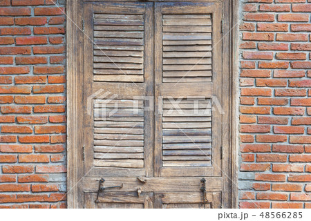 Wooden door with red bricks wall 48566285
