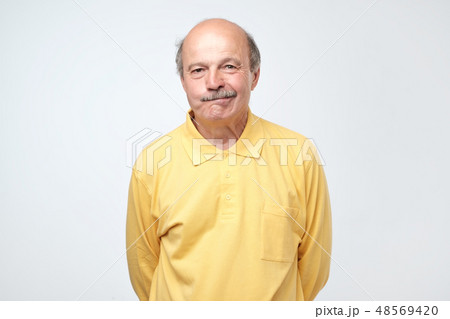 Nervous doubtful man frowning biting lips Nervous doubtful man frowning biting lips 48569420