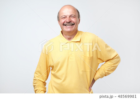 Mature adult man laughing looking at the camera Mature adult man laughing looking at the camera 48569981