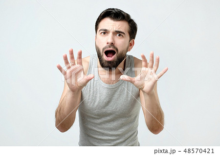 Young man is afraid and terrified with fear   48570421