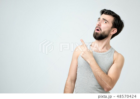 Attractive young spanish man pointing up  48570424