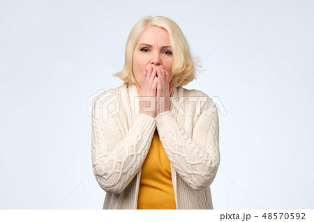 Senior woman covering face with hands Senior woman covering face with hands 48570592