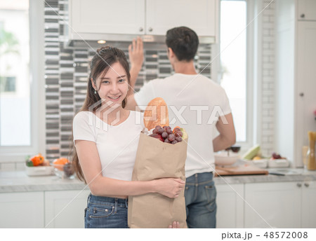 Asian couple in the kitchen Asian couple in the kitchen 48572008