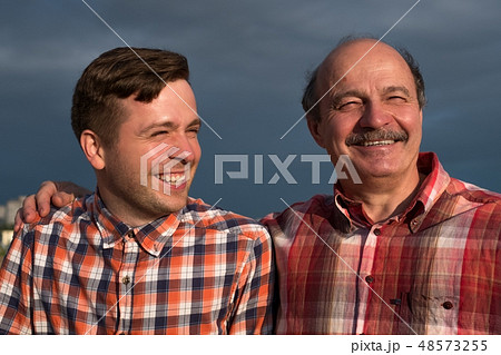 portrait of happy father and son walking outdoors. portrait of happy father and son walking outdoors. 48573255