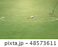 Golfer putting golf ball on the green, Motion blur 48573611