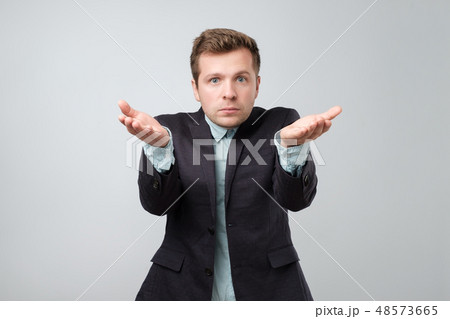 European  young man, arms out asking who cares  48573665