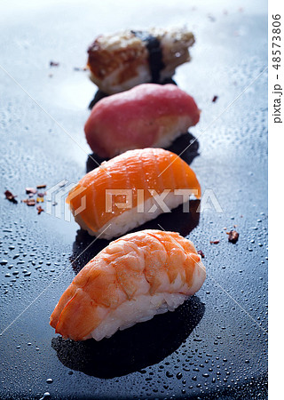 Sashimi, uramaki and nighiri, Japanese dish consisting of rice, salmon or tuna, shrimp in black with Sashimi, uramaki and nighiri, Japanese dish consisting of rice, salmon or tuna, shrimp in black with 48573806