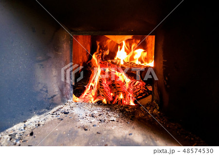 Burning logs in a fireplace at old house Burning logs in a fireplace at old house 48574530