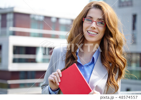 Young businesswoman (real estate agent) presenting detached mode Young businesswoman (real estate agent) presenting detached mode 48574557