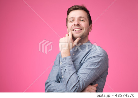 Confident young handsome man in blue shirt  Confident young handsome man in blue shirt  48574570