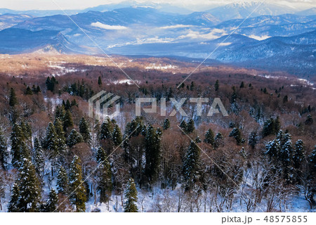 Beautiful distant winter mountains landscape with mist Beautiful distant winter mountains landscape with mist 48575855