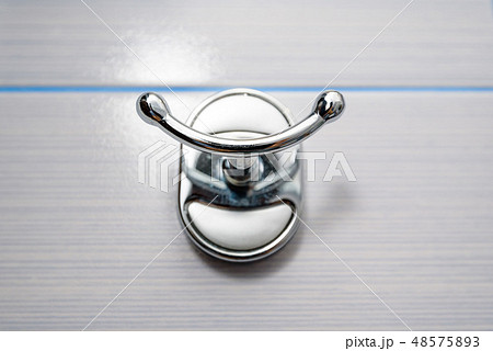 Stainless steel towel hanger on wall in bathroom 48575893