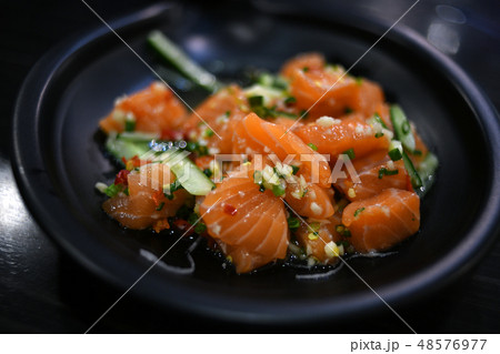 Salmon salad on black plate Salmon salad on black plate 48576977